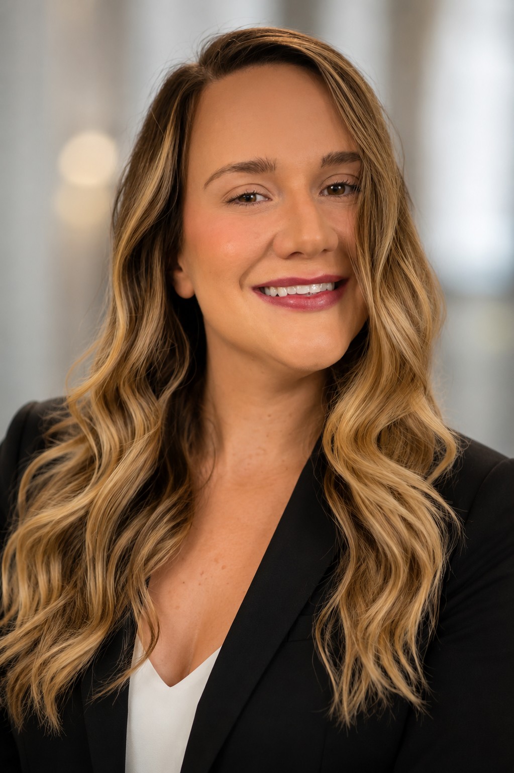 Portrait of Ashlee Hawk in a black blazer and white top