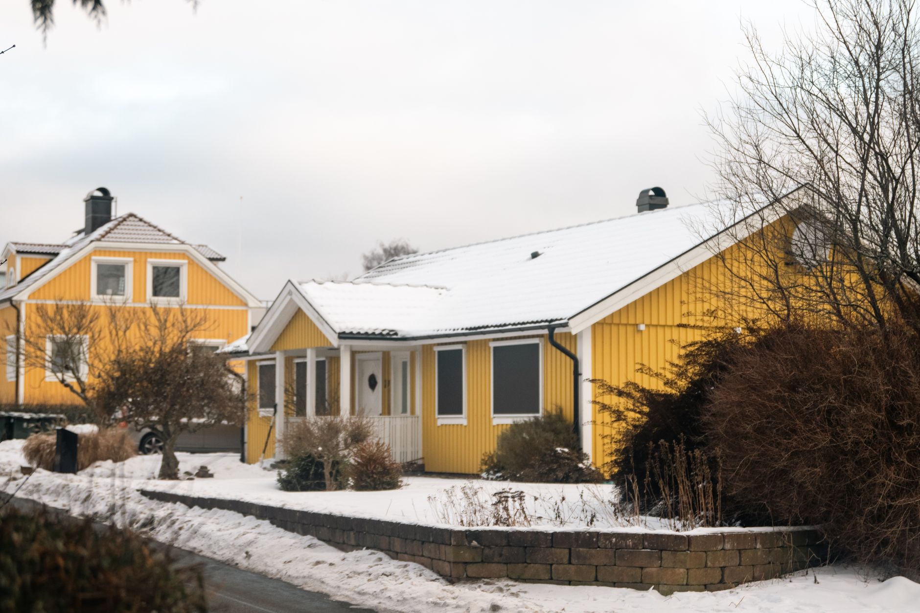 Snow-covered houses on a residential street in winter