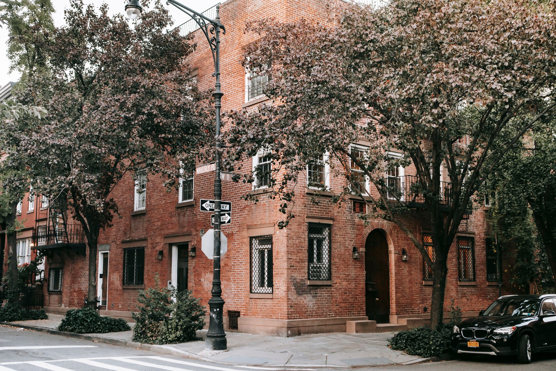 Older brick residence on a leafy street corner, illustrative of historic urban housing