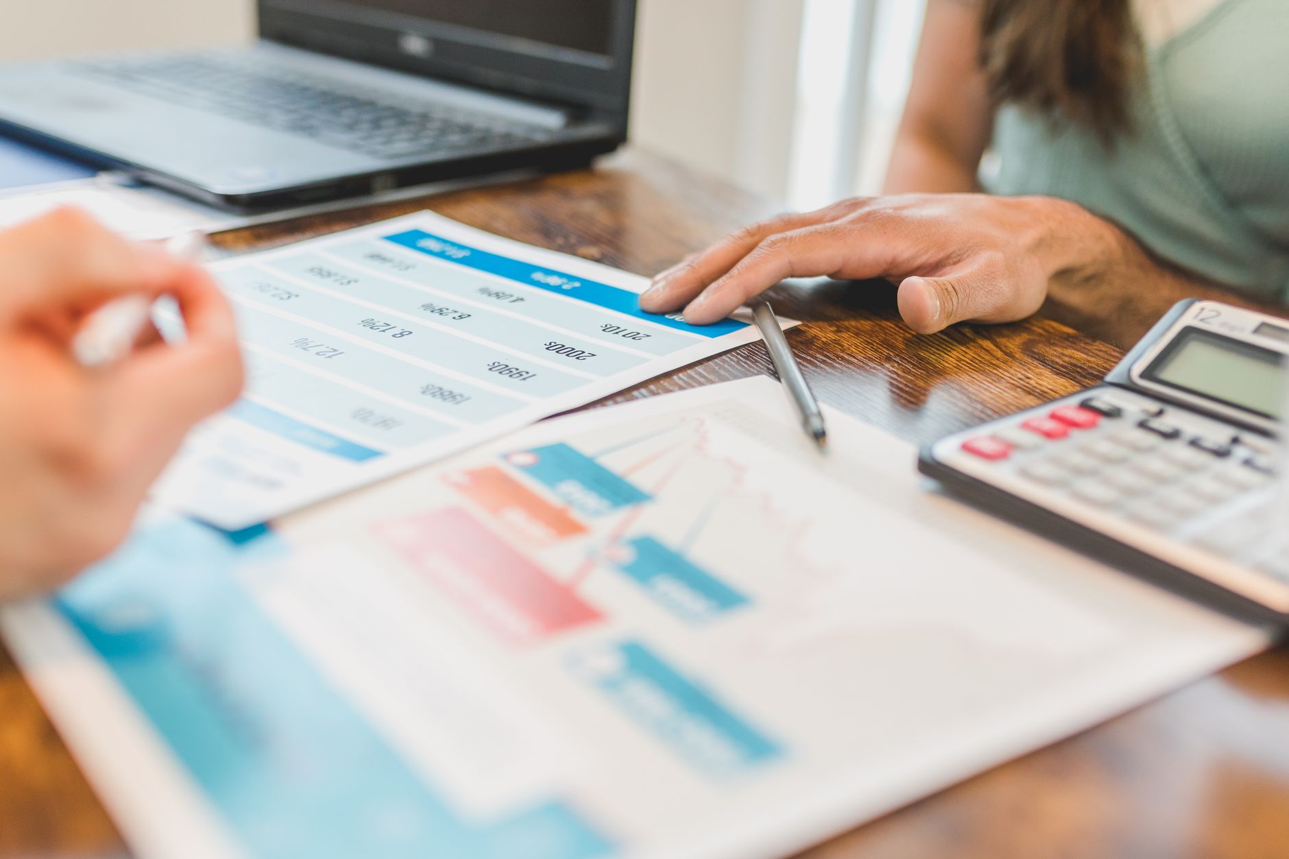 Buyer reviewing financial documents and a calculator at a desk