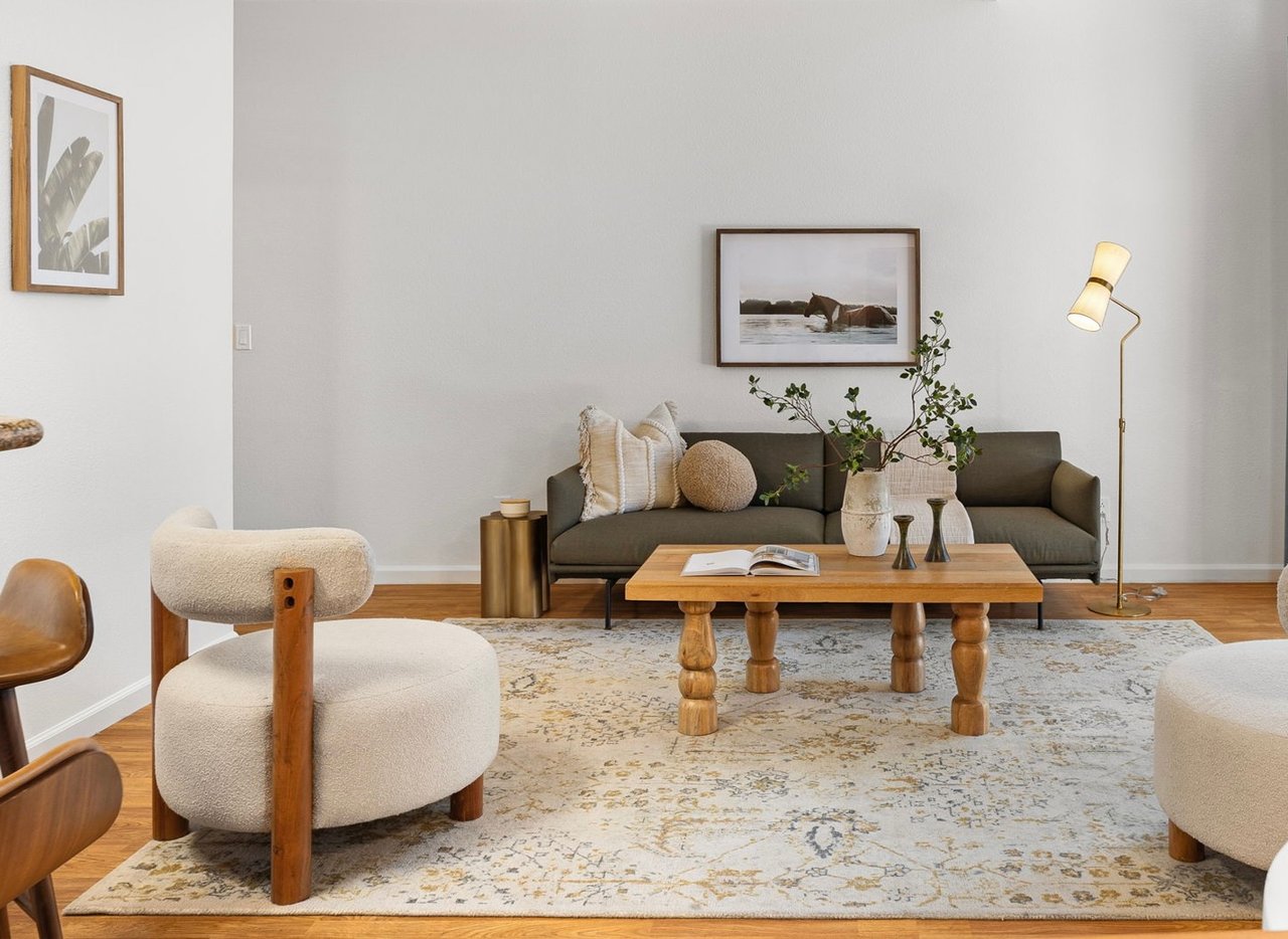 Warm modern living room with natural wood and soft neutral furnishings