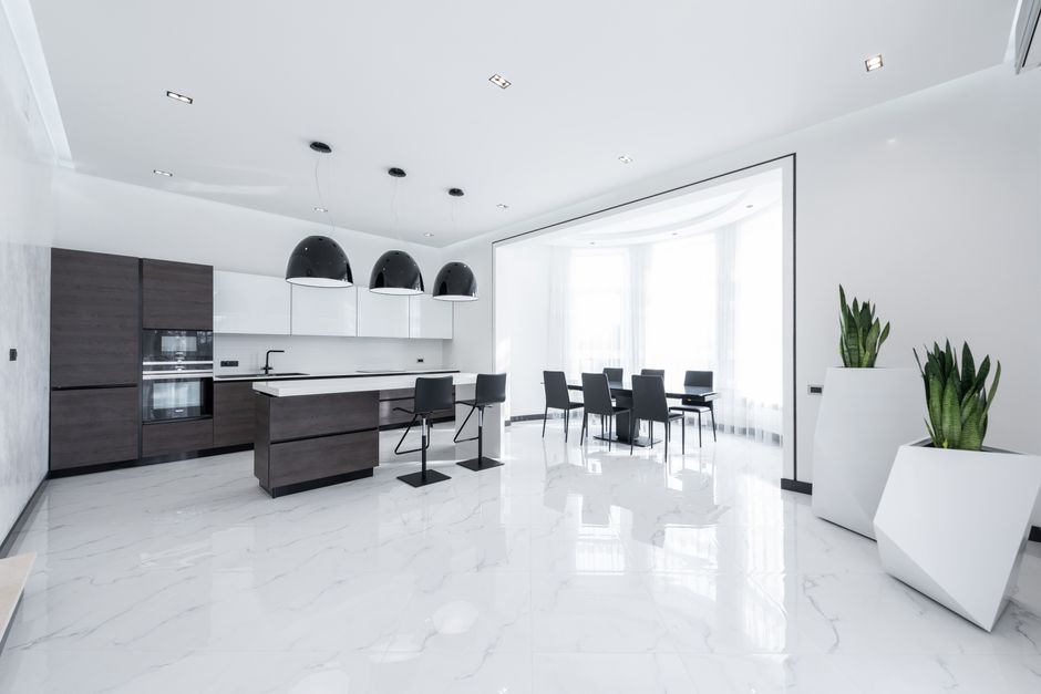 Refined modern kitchen with marble floors and greenery
