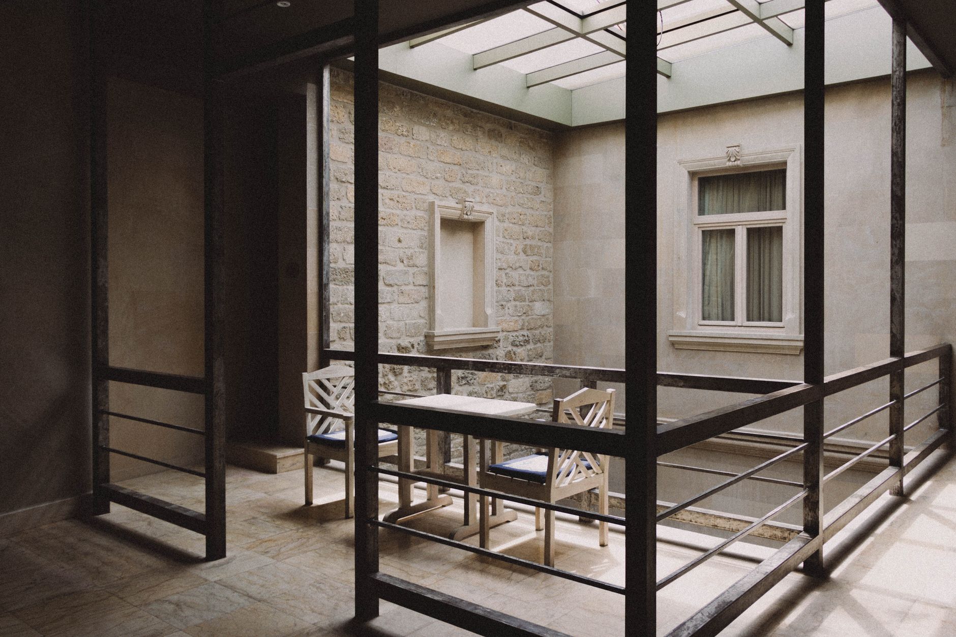 Quiet interior courtyard with sculptural furniture and natural light