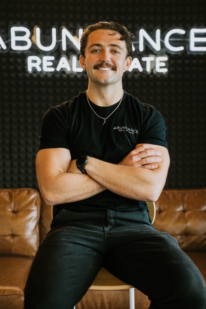 Joseph Anselmo seated in the Abundance Real Estate office