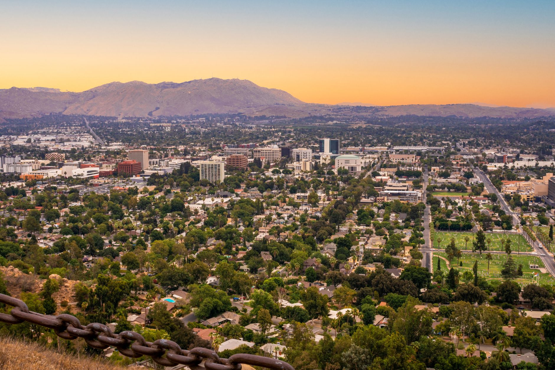 Riverside cityscape and mountains at twilight