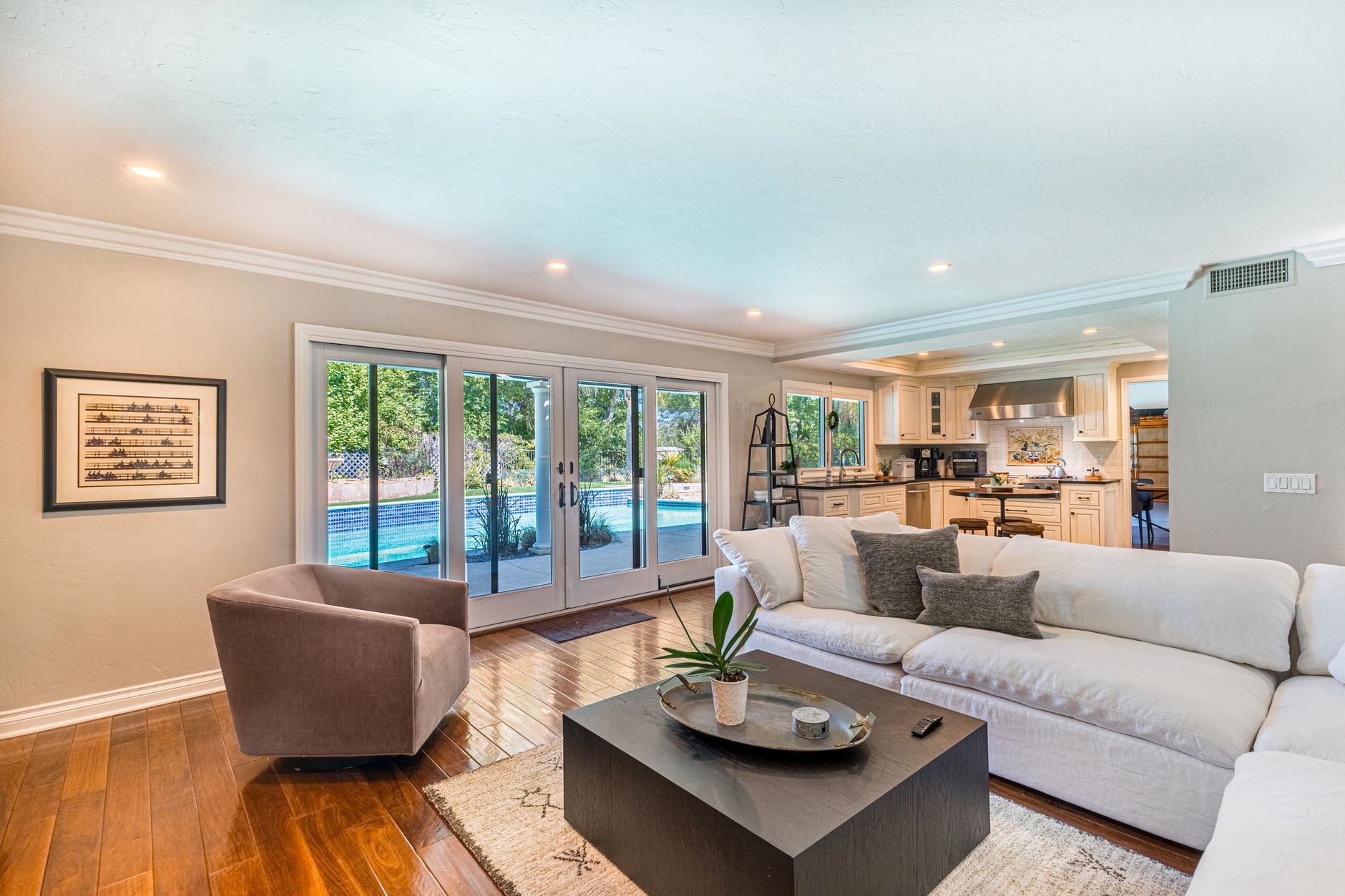 Contemporary Southern California living room opening to a pool