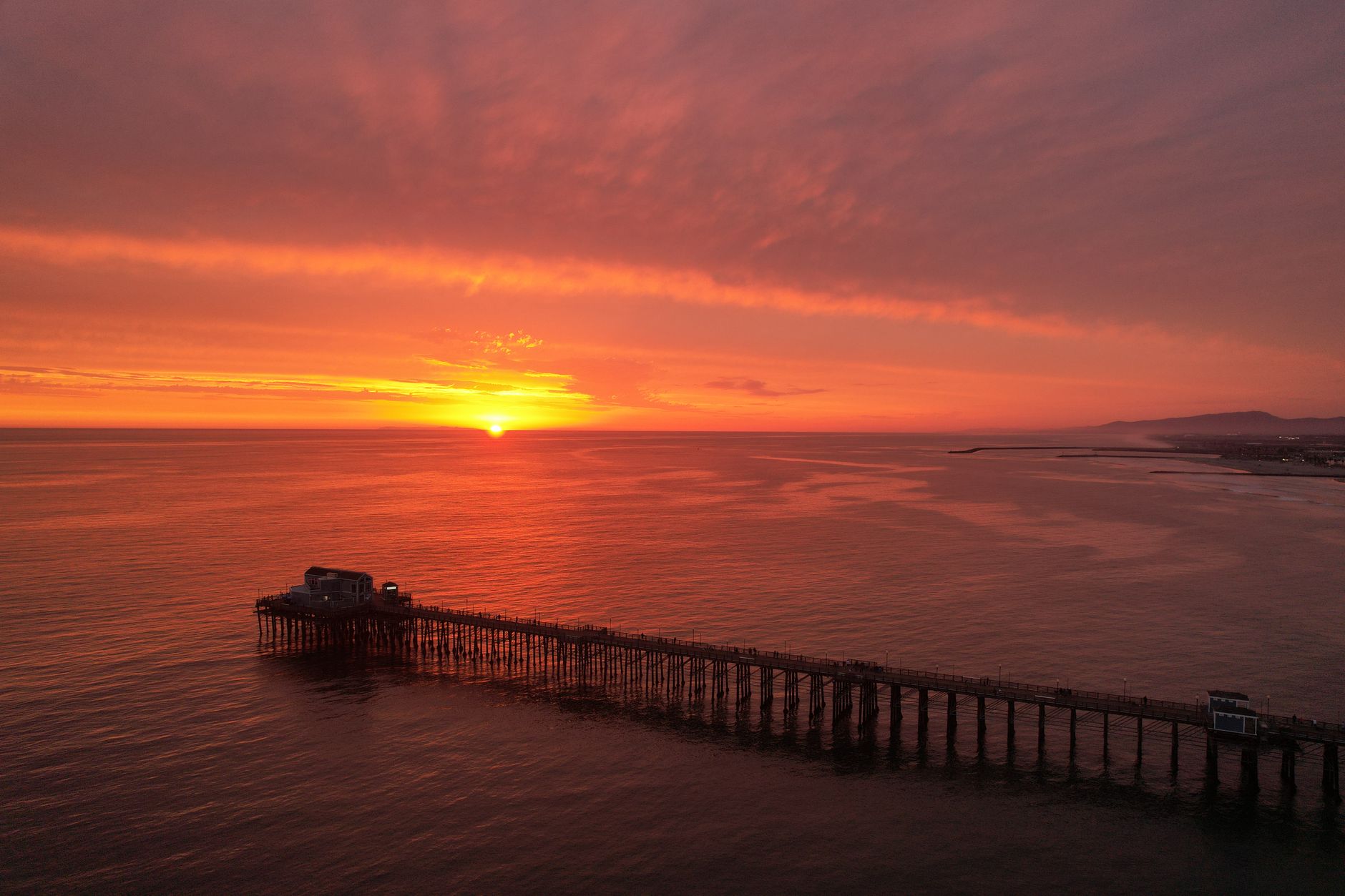 Oceanside Pier and coastline at sunset