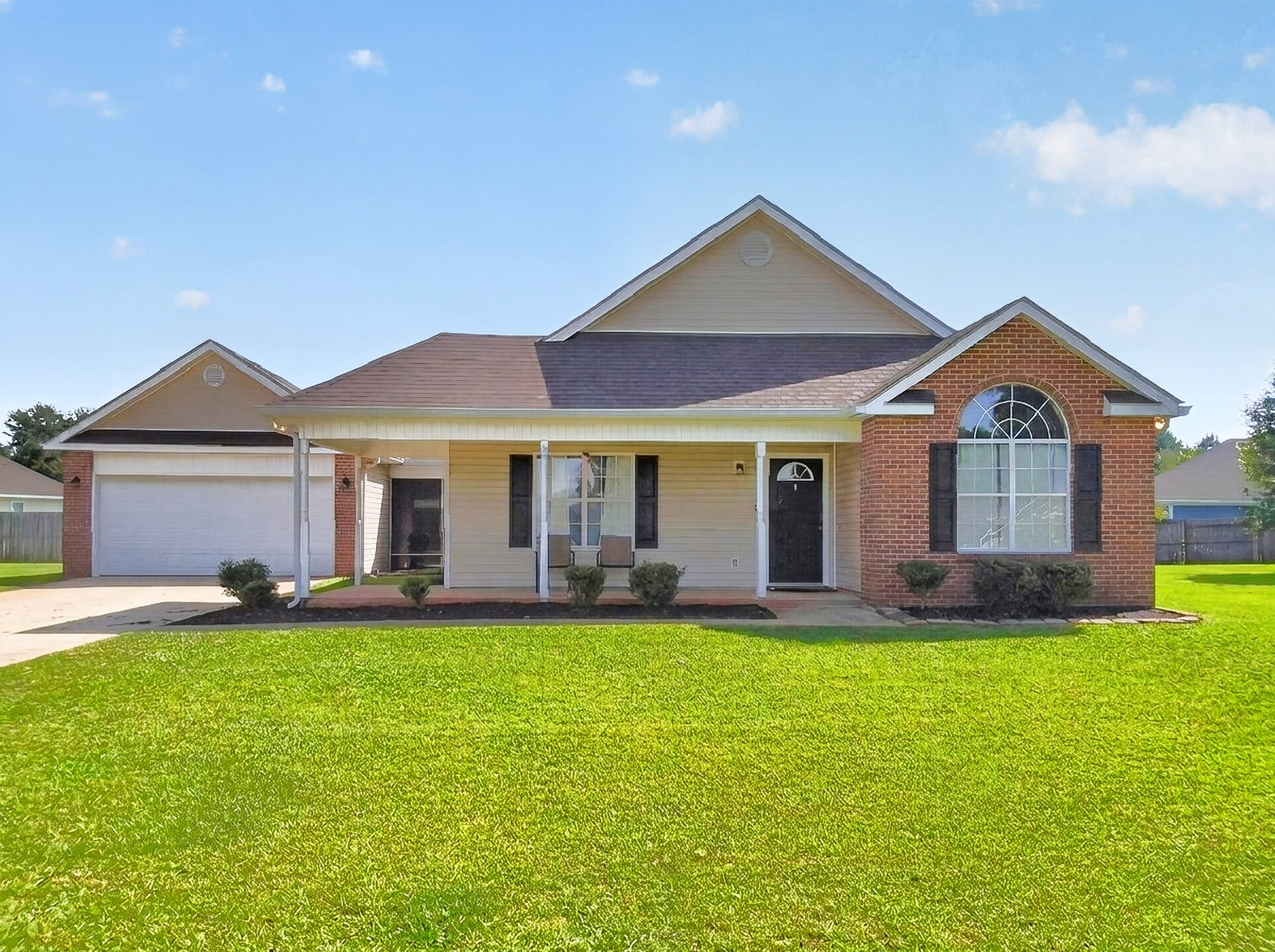 Front exterior of 108 Langdon Ct in Bonaire, Georgia, with a brick-and-siding facade, attached garage, and lawn