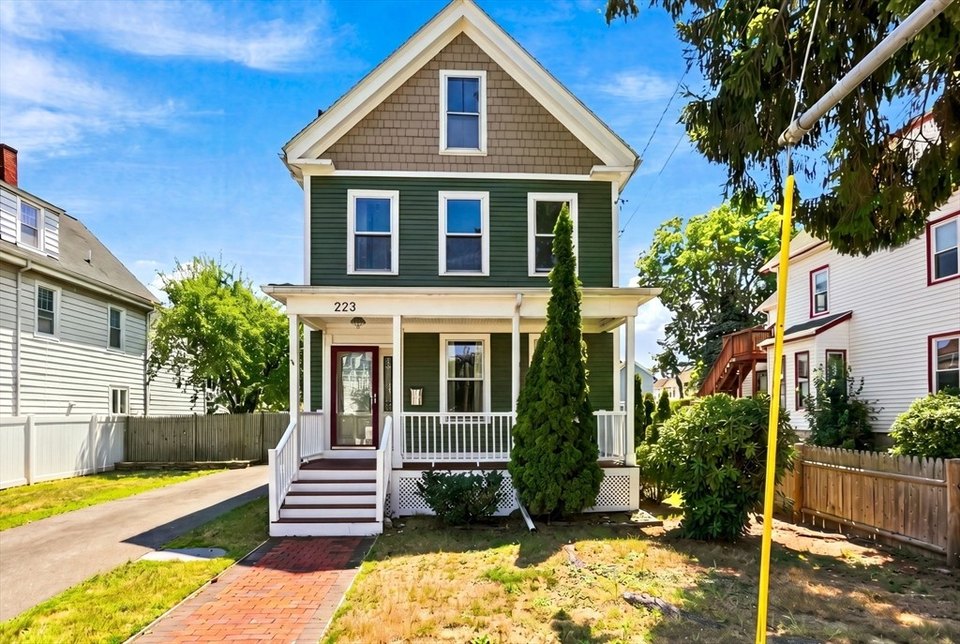 Sunny two-story New England home with a welcoming front porch