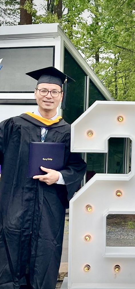 Chris Yang in graduation cap and gown
