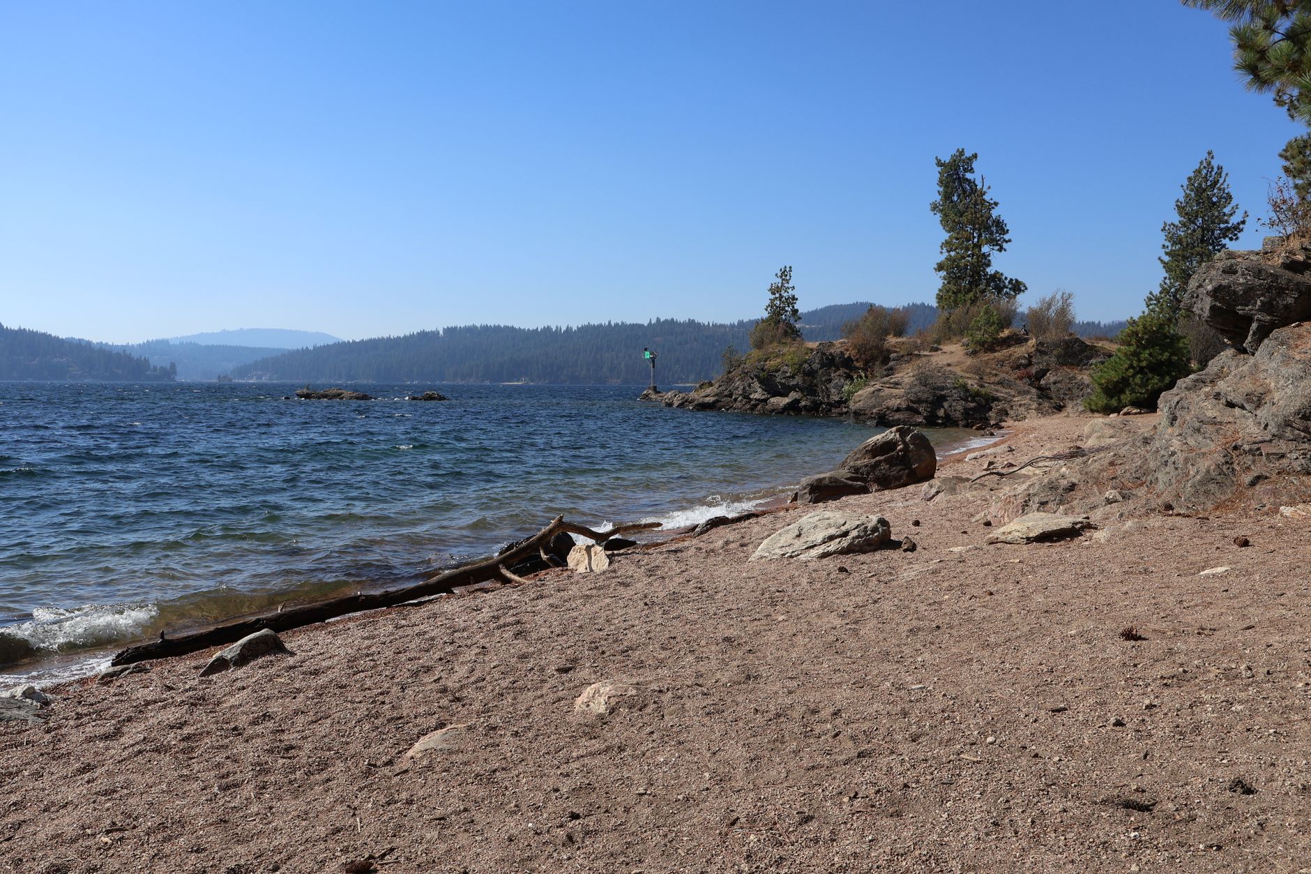 Calm North Idaho lake bordered by mountain scenery