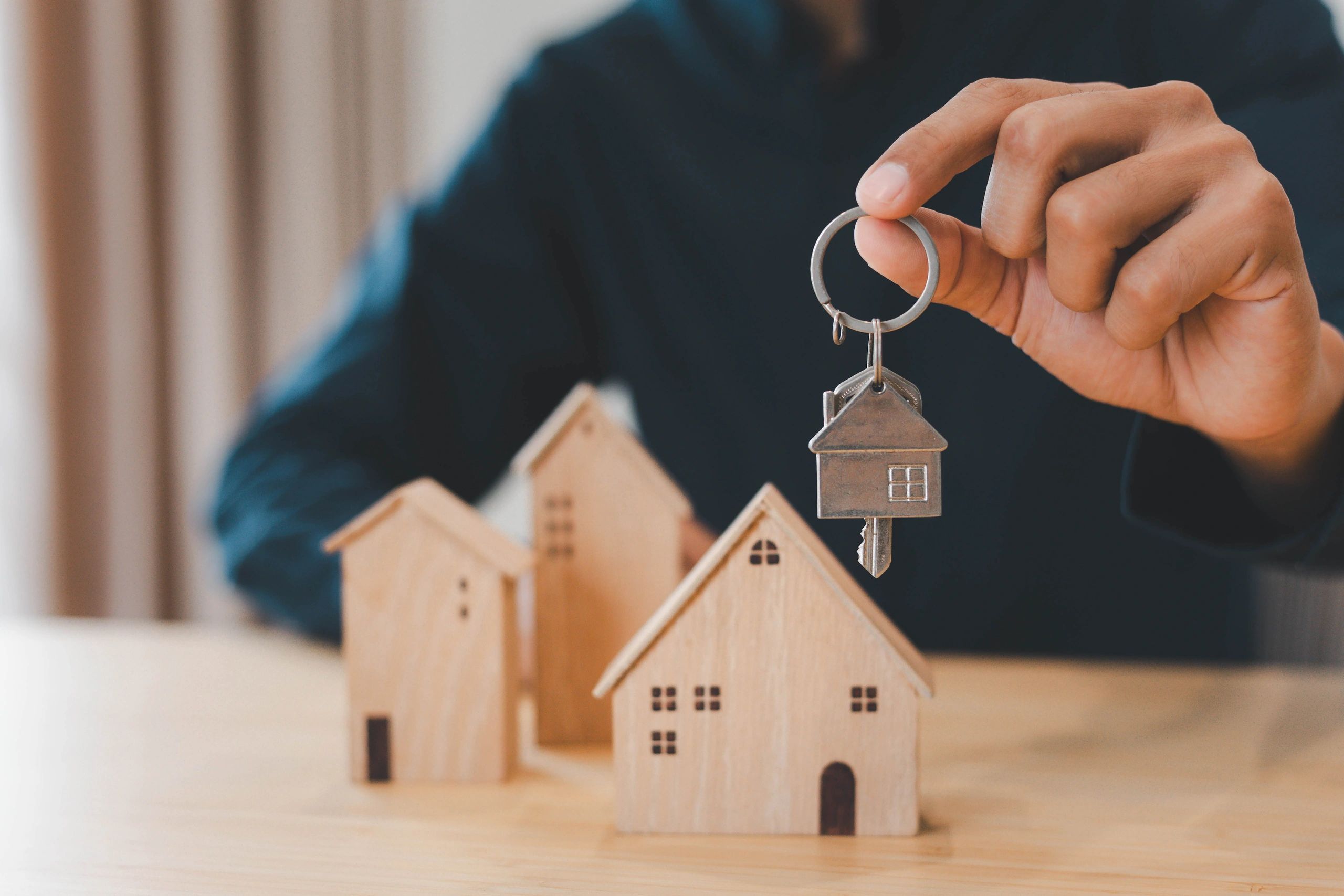 House keys and small model homes representing a real estate consultation