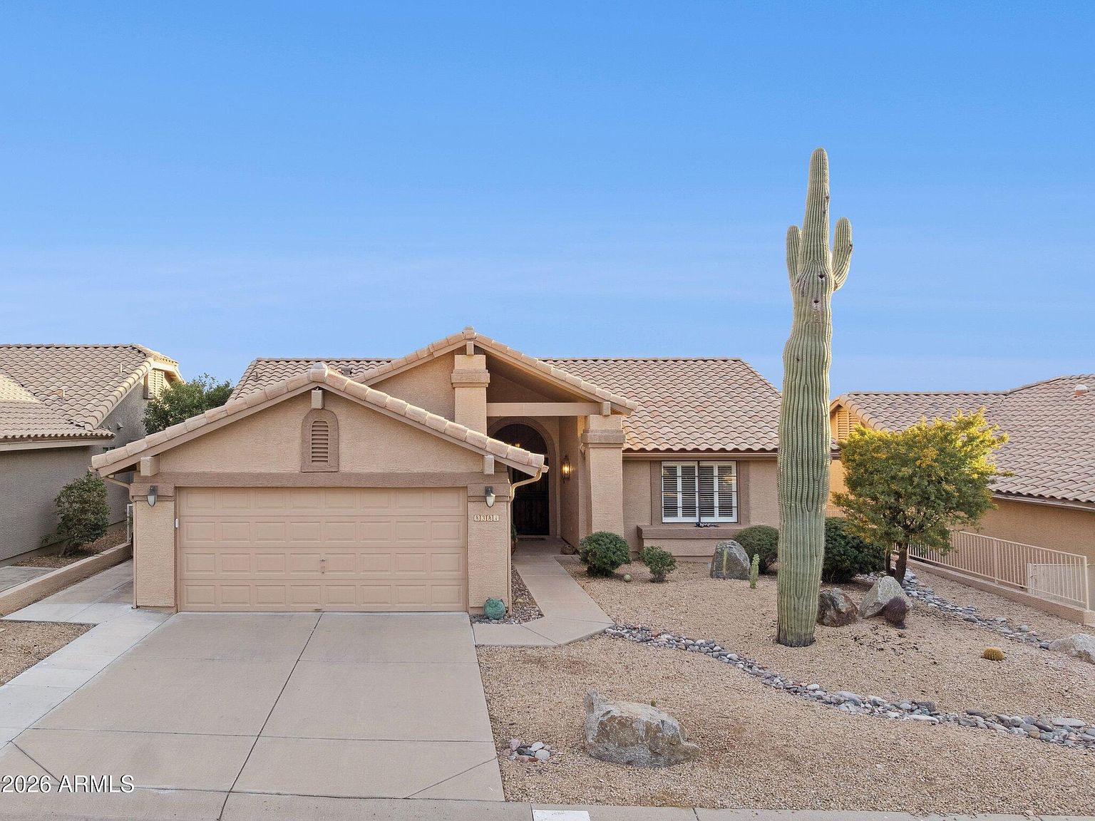 Stucco home and saguaro at 8381 E Golden Cholla Drive