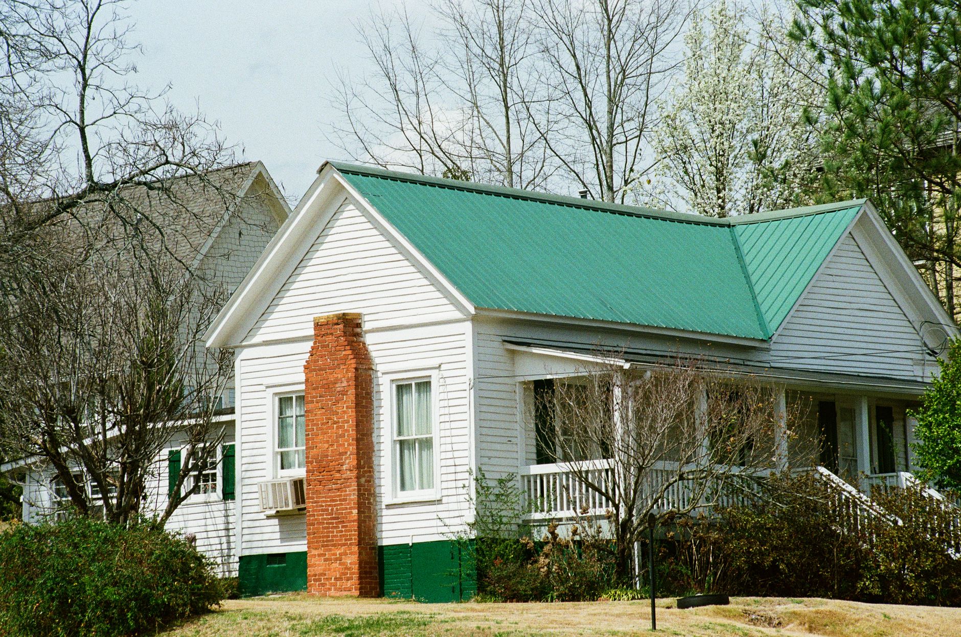 Historic Georgia home framed by early spring trees