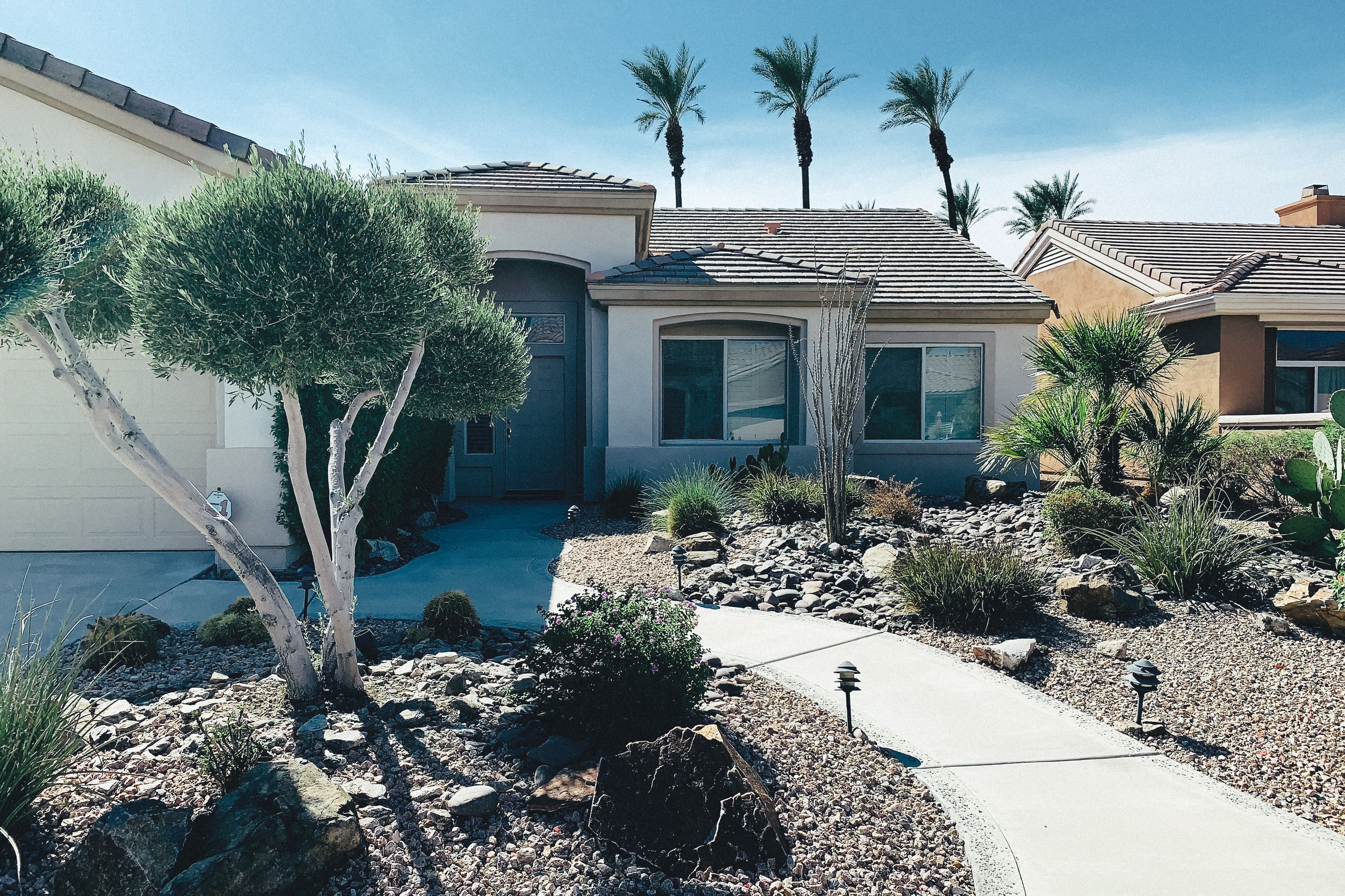 Henderson home with desert landscaping and palm trees
